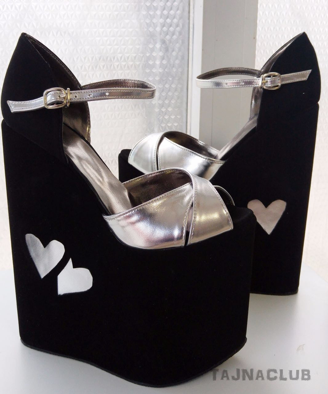 Ankle strap wedge sandals in black and silver.