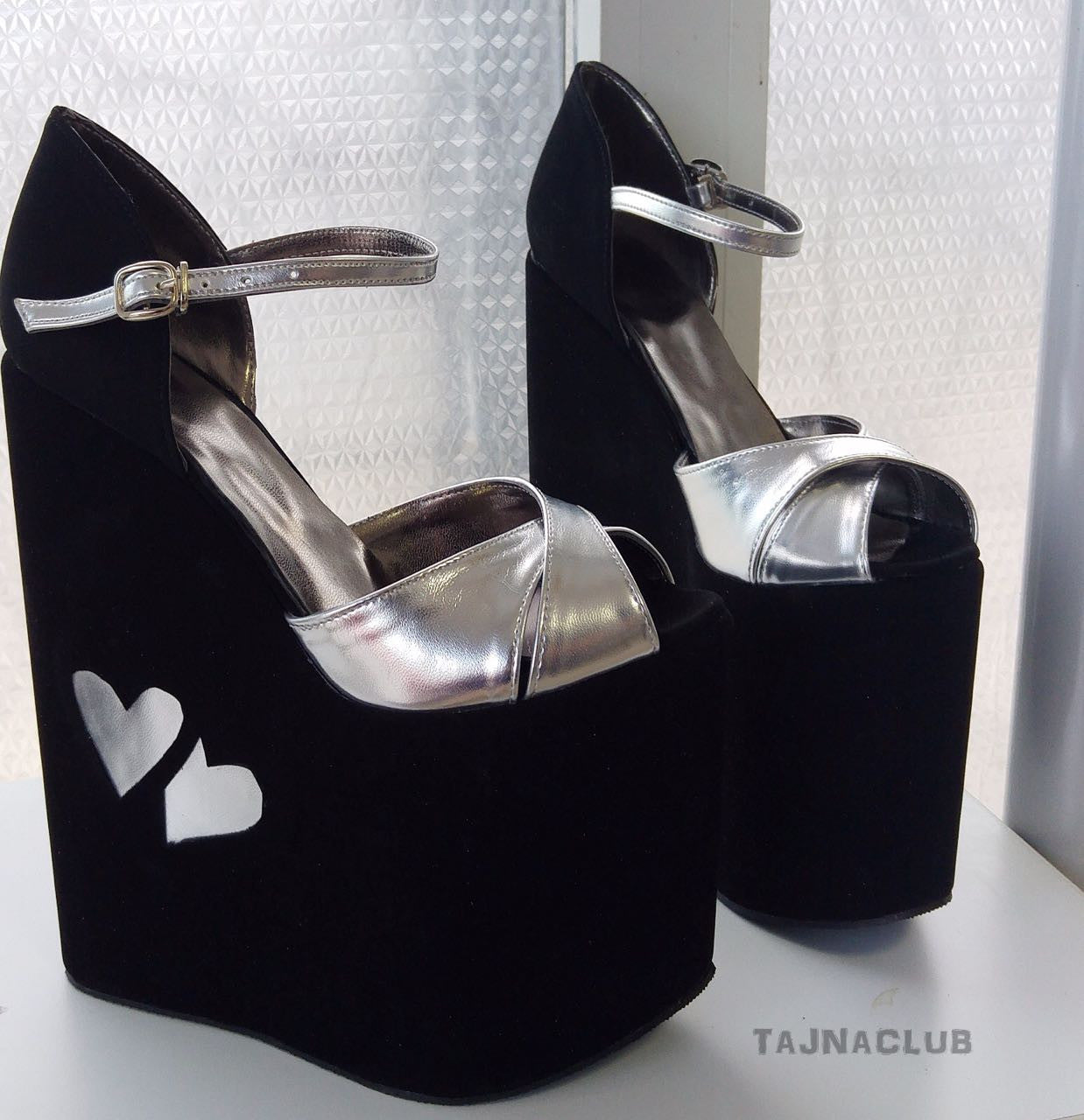 Ankle strap wedge sandals in black and silver.